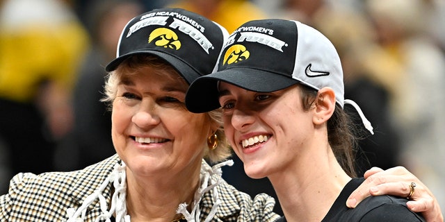 Head coach Lisa Bluder, left, and Caitlin Clark of the Iowa Hawkeyes pose for a photo after defeating the Louisville Cardinals 97-83 in the Elite Eight of the NCAA Tournament at Climate Pledge Arena March 26, 2023, in Seattle.