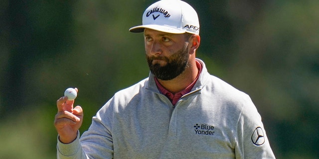 Jon Rahm of Spain waves after his putt on the third hole during the final round of the Masters golf tournament at Augusta National Golf Club on Sunday, April 9, 2023, in Augusta, Ga.