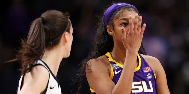 Angel Reese of the LSU Lady Tigers reacts toward Caitlin Clark of the Iowa Hawkeyes during the championship game on April 2, 2023, in Dallas, Texas.