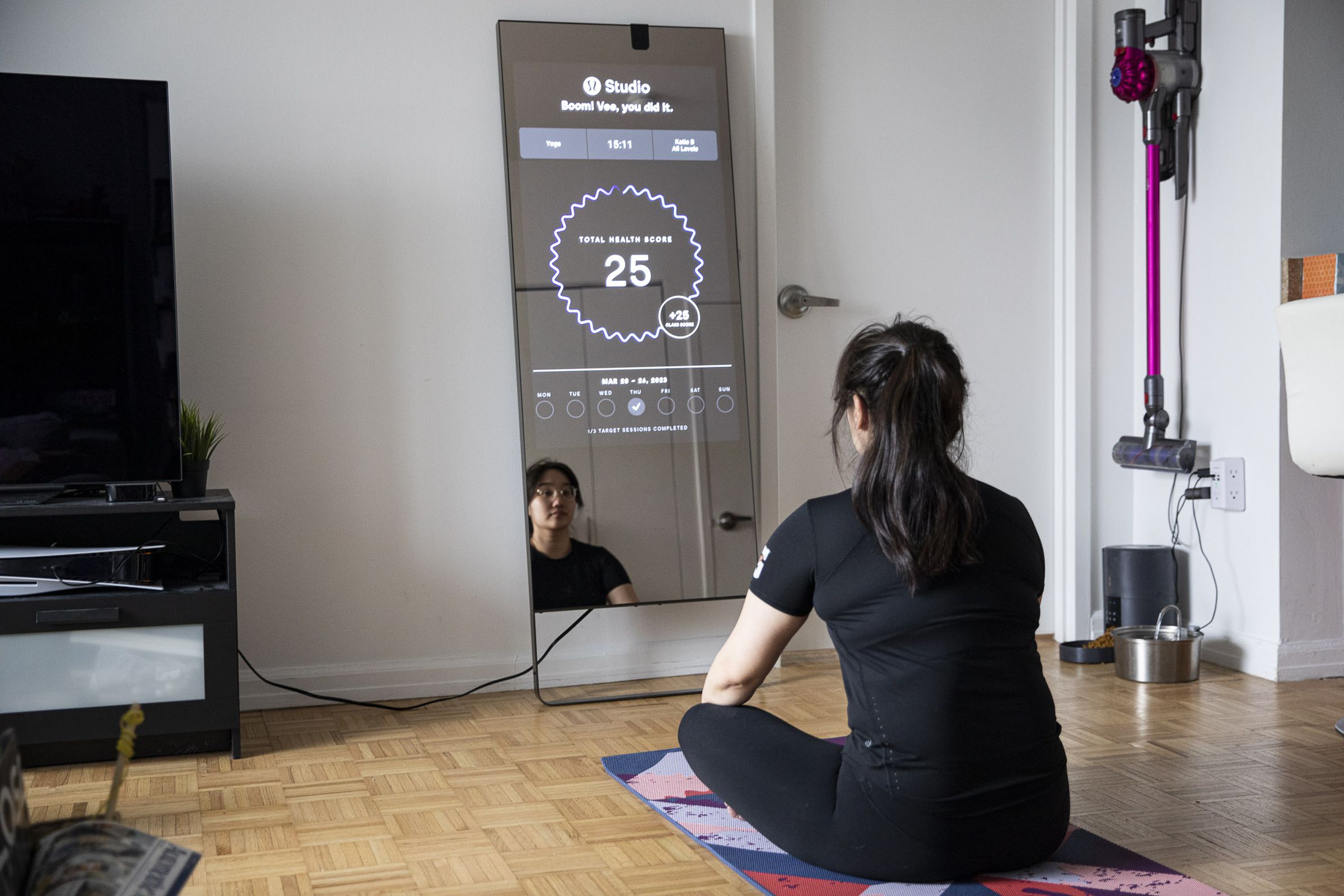 Person sitting in front of Mirror looking at post-workout stats.