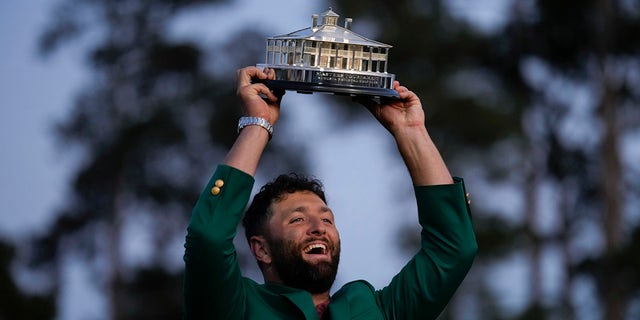 Jon Rahm, of Spain, celebrates holding the Masters trophy winning the Masters golf tournament at Augusta National Golf Club on Sunday, April 9, 2023, in Augusta, Ga.