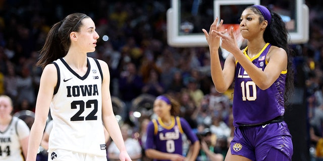 LSU Lady Tigers forward Angel Reese, #10, gestures to Iowa Hawkeyes guard Caitlin Clark, #22, after the game during the final round of the Women's Final Four NCAA tournament at the American Airlines Center in Dallas April 2, 2023.