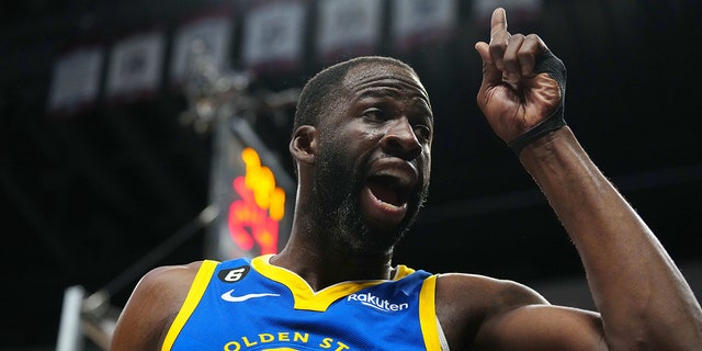 Golden State Warriors forward Draymond Green, #23, reacts towards a Denver Nuggets fan in the third quarter at Ball Arena in Denver April 2, 2023.