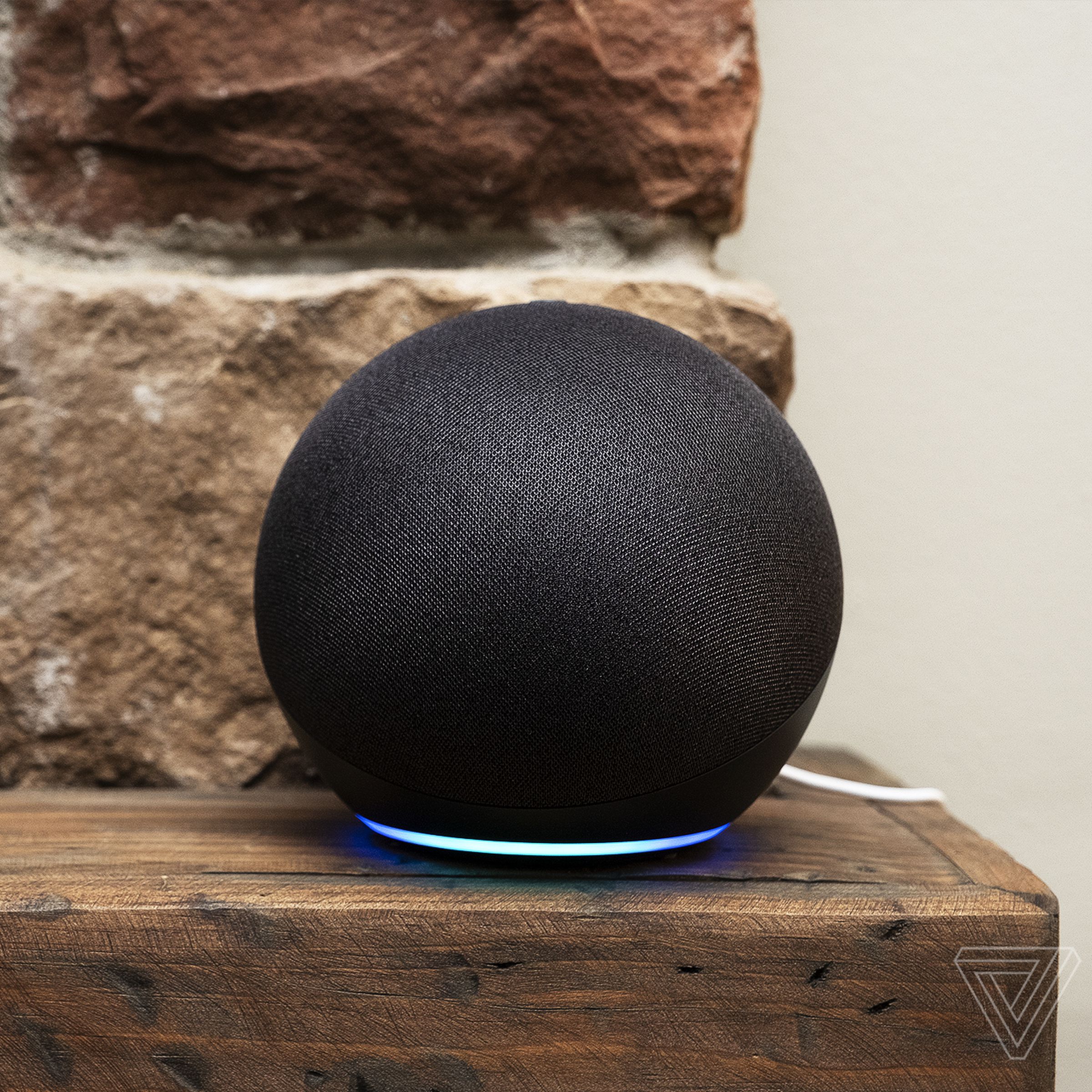 An Echo smart speaker on a mantlepiece with a skeleton couple.