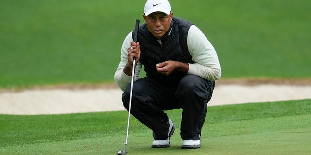 Tiger Woods lines up a putt on the 16th hole during the weather-delayed second round of the Masters at Augusta National Golf Club on Saturday, April 8, 2023.