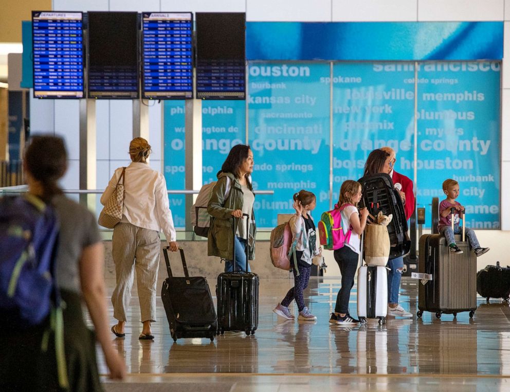 PHOTO: Passengers makes their way to to and from their gates during the Memorial Day weekend getaway at John Wayne Airport in Santa Ana, Calif. May 26, 2022.