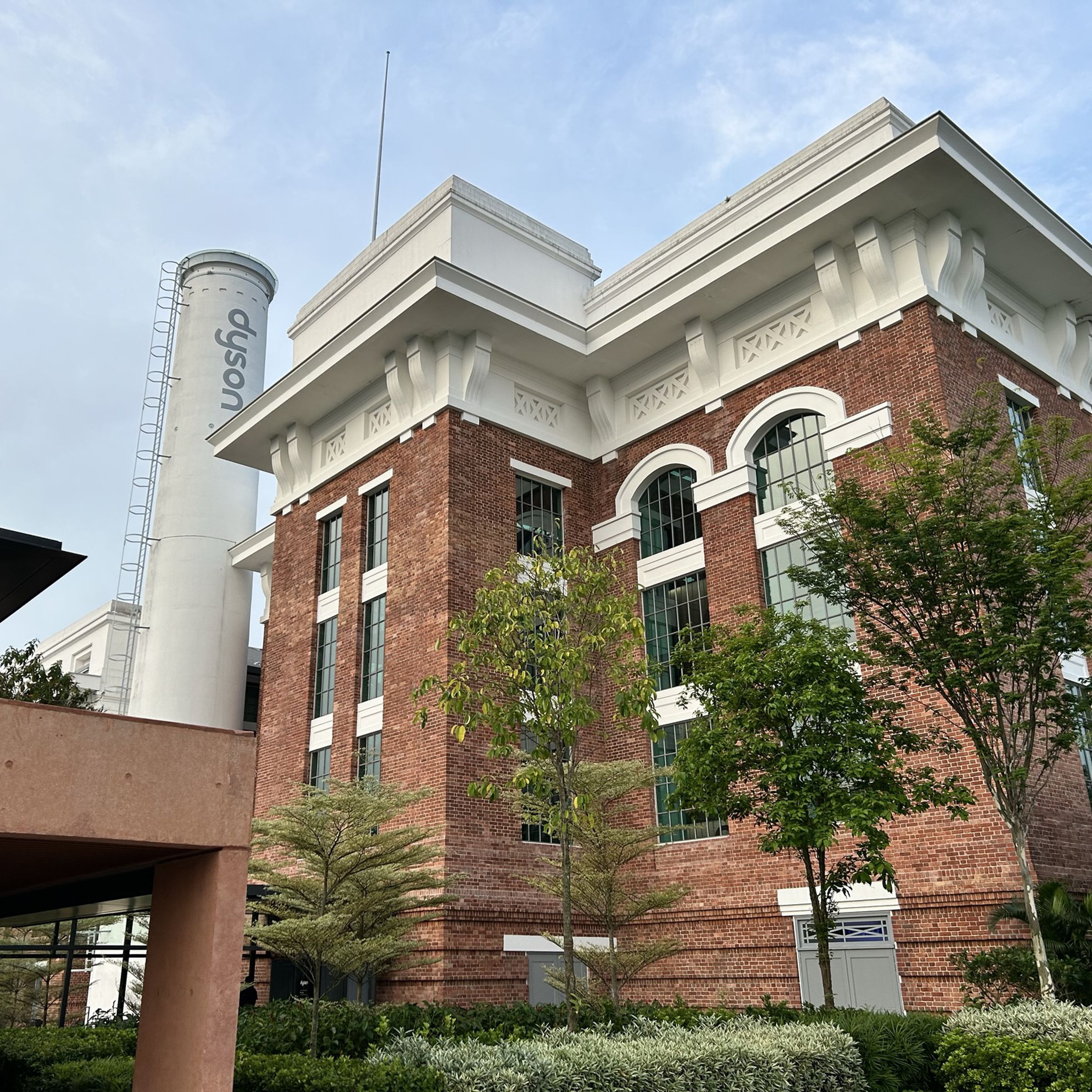 A brick building with a Dyson logo on what was once a smokestack.