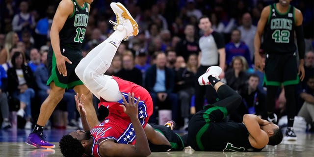 Joel Embiid and Grant Williams on the floor