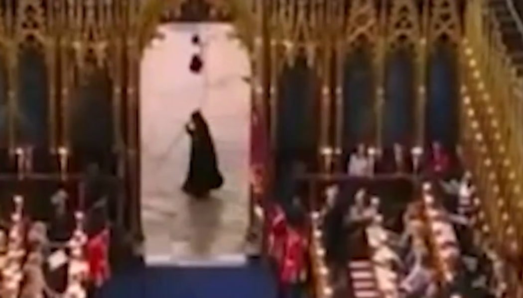 Cloaked figure runs past Westminster Abbey during coronation | Lifestyle | Independent TV - The Independent