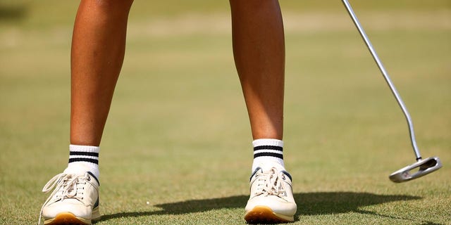 A golfer putts at the 2022 Division III Women's Golf Championship