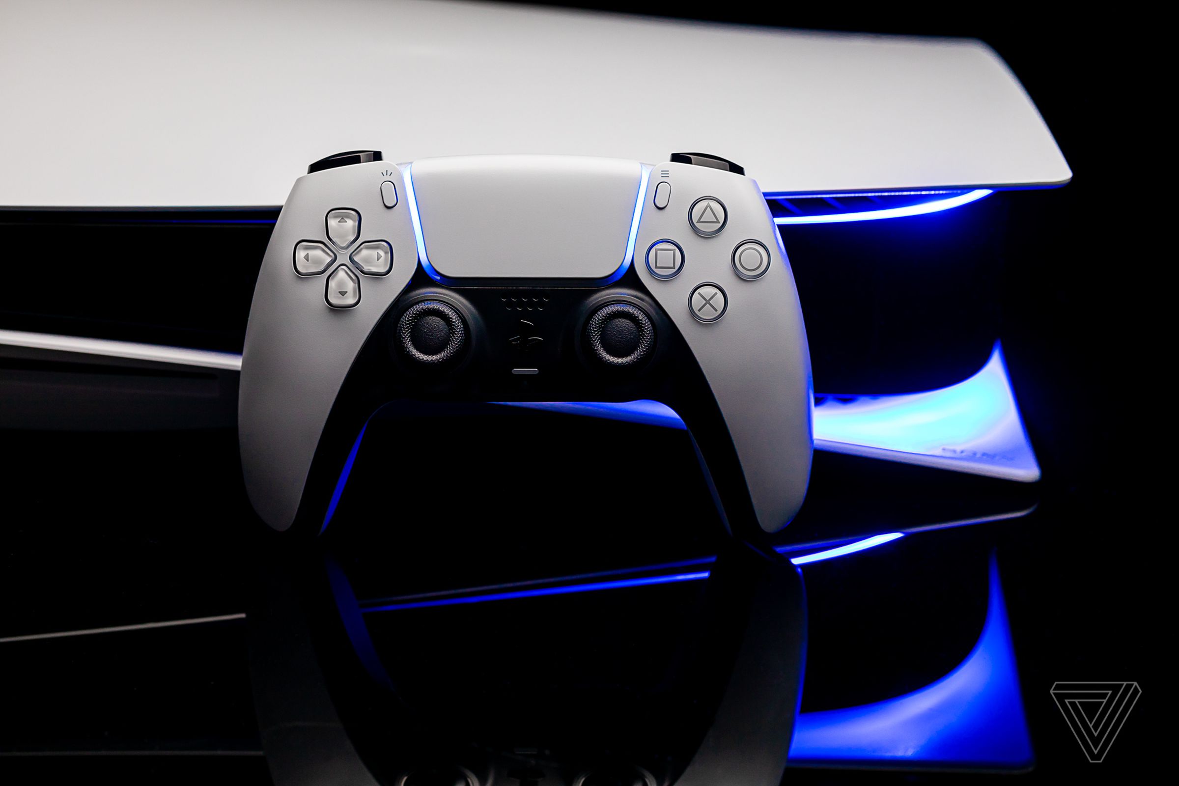 A PlayStation 5 DualSense controller rests on a PlayStation 5 console.