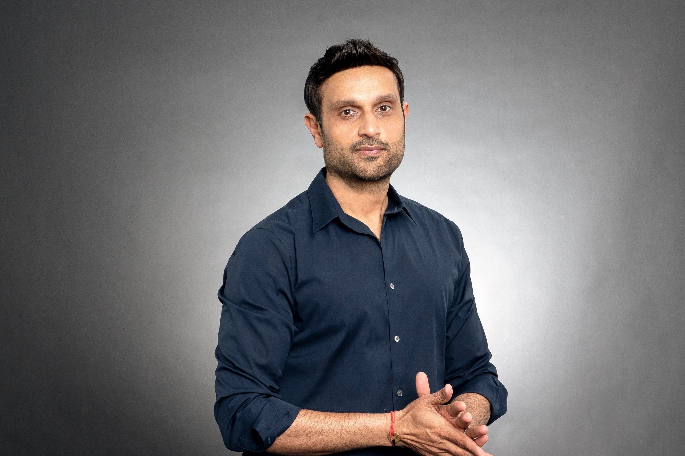 A portrait photograph of Riot Games CEO Dylan Jadeja against a black background.