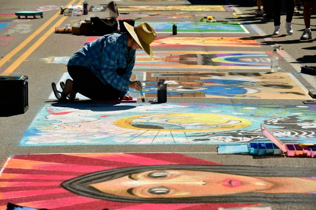 Chalk artist Diedra Olin works on ...