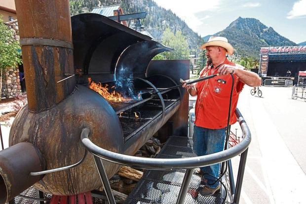 Turkey Crossing BBQ's Jay Spurling, of Hugo, Colo., prepares the smoker with a torch ahead of Colorado BBQ Challenge Thursday June 15, 2017, in Frisco. (Hugh Carey, Summit Daily)