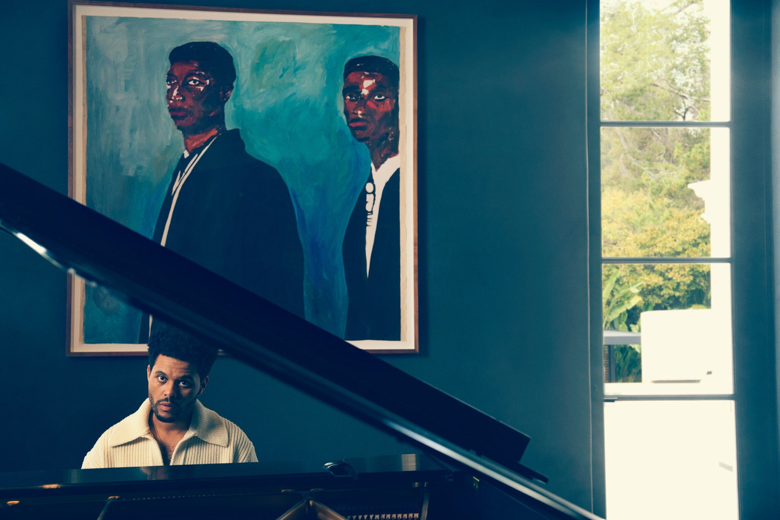 Abel Tesfaye at the piano wearing a sweater by Bottega Veneta.