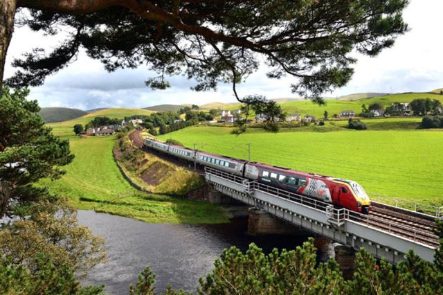 p38 business ABINGTON, SCOTLAND - AUGUST 29: A Virgin train passes along the West Coast mainline route near Abington on August 29, 2012 in Scotland. Earlier this month Virgin lost out to First Group in their bid to run a 13 year West Coast franchise starting in December and are now starting a legal challenge to try and maintain the service it has operated for the past 15 years. (Getty)