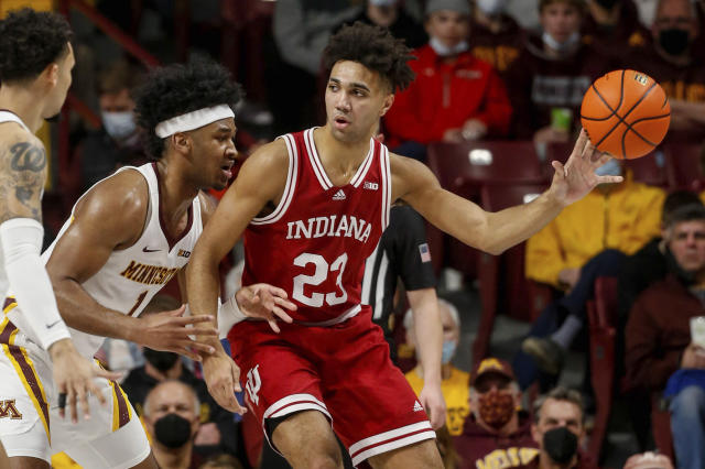 Indiana forward Trayce Jackson-Davis (23) looks to pass as Minnesota forward Eric Curry (1) defends him at an NCAA college basketball game Sunday, Feb. 27, 2022, in Minneapolis. (AP Photo/Bruce Kluckhohn)