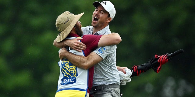 Nick Taylor celebrates with caddie