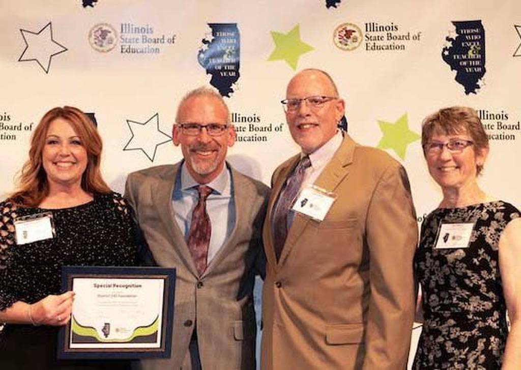 From left, District 230 Foundation Executive Director Heather Gordon, State Superintendent of Education Tony Sanders, foundation treasurer Andy Stefo and foundation board President Ann Oliver gather after the State Board of Education presented the foundation with a Those Who Excel Special Recognition award.