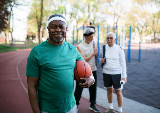 Older man holding a basketball