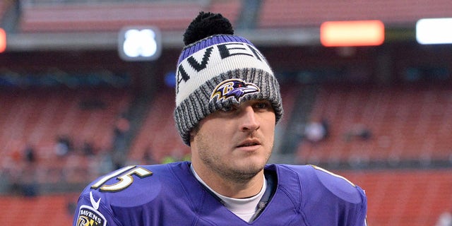 Ryan Mallet walks on field in beanie