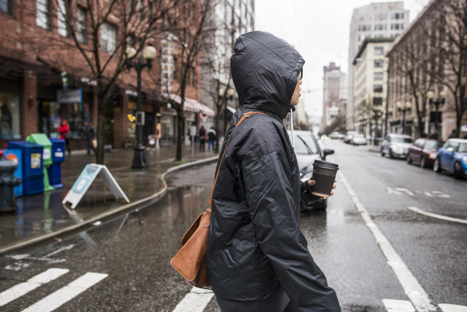 person walking in seattle wearing a hooded coat