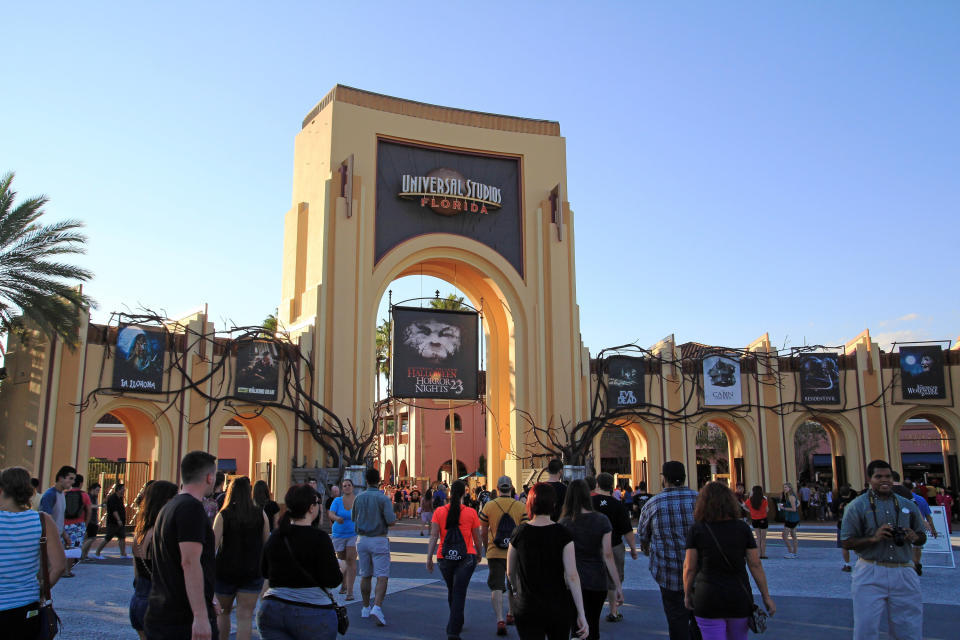 people outside the entrance of universal studios in florida