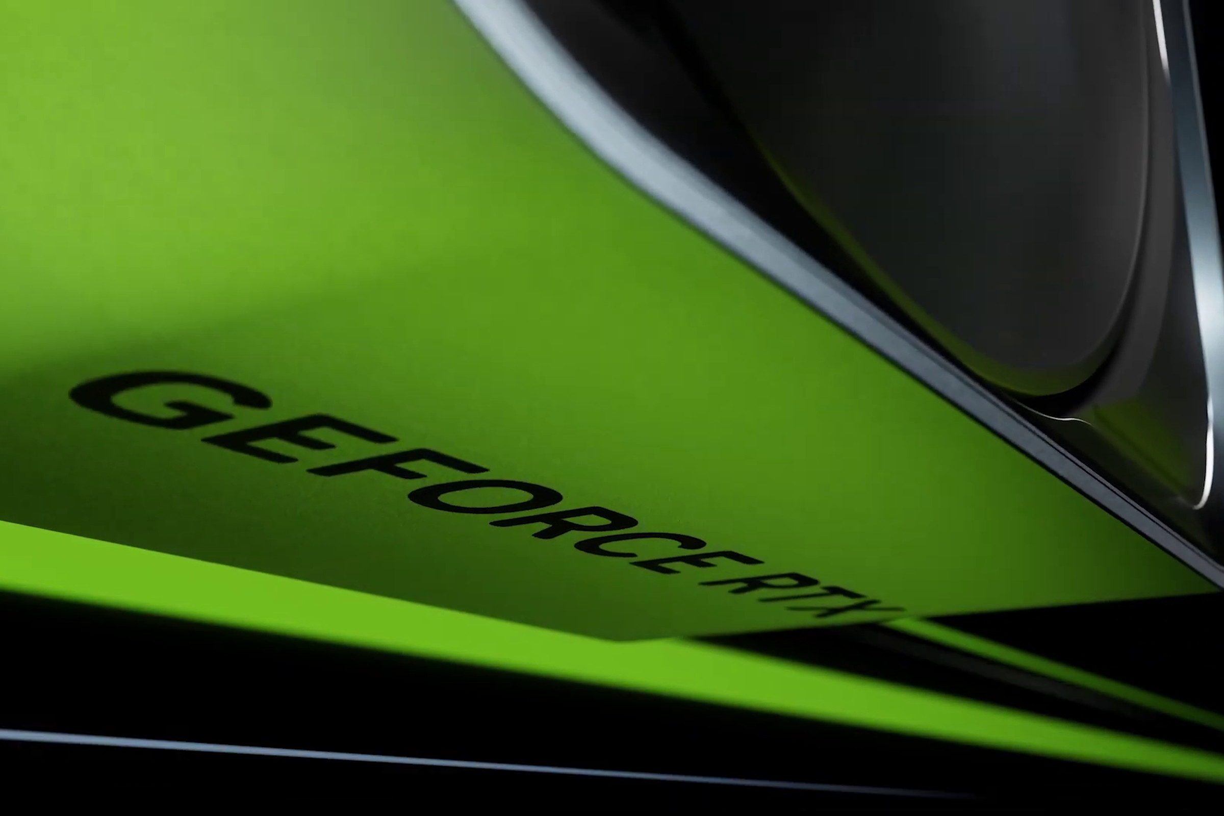 A metal GPU shroud reading GeForce RTX lit up green.