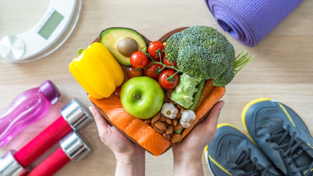 Fruits and vegetables held in the shape of a heart