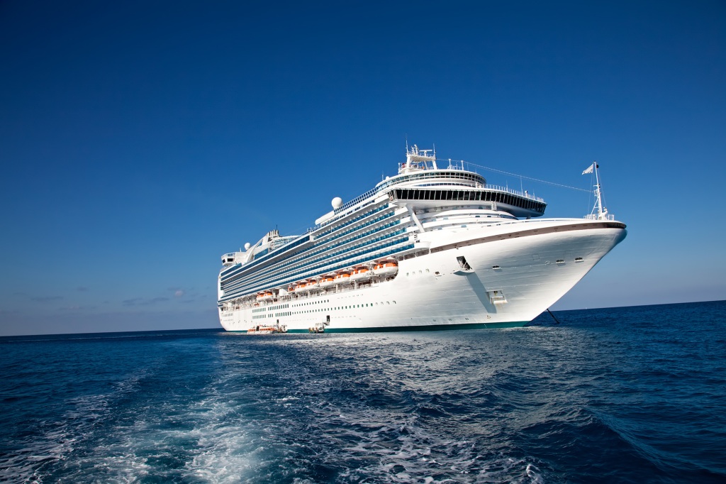 "Eastern Caribbean Sea - February 8, 2010: A luxury cruise ship anchors in the water as passengers are taken by ferry to the local tropical island for a day of sun and fun."