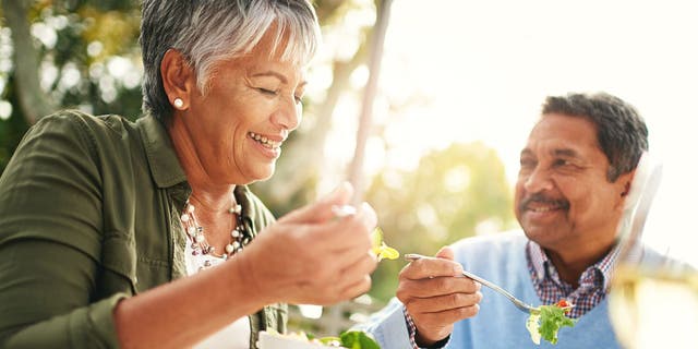 Happy older couple eating