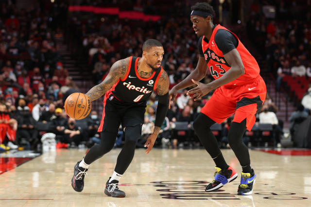 PORTLAND, OREGON - NOVEMBER 15: Damian Lillard #0 of the Portland Trail Blazers dribbles against Pascal Siakam #43 of the Toronto Raptors during the first quarter at Moda Center on November 15, 2021 in Portland, Oregon. NOTE TO USER: User expressly acknowledges and agrees that, by downloading and or using this photograph, User is consenting to the terms and conditions of the Getty Images License Agreement. (Photo by Abbie Parr/Getty Images)