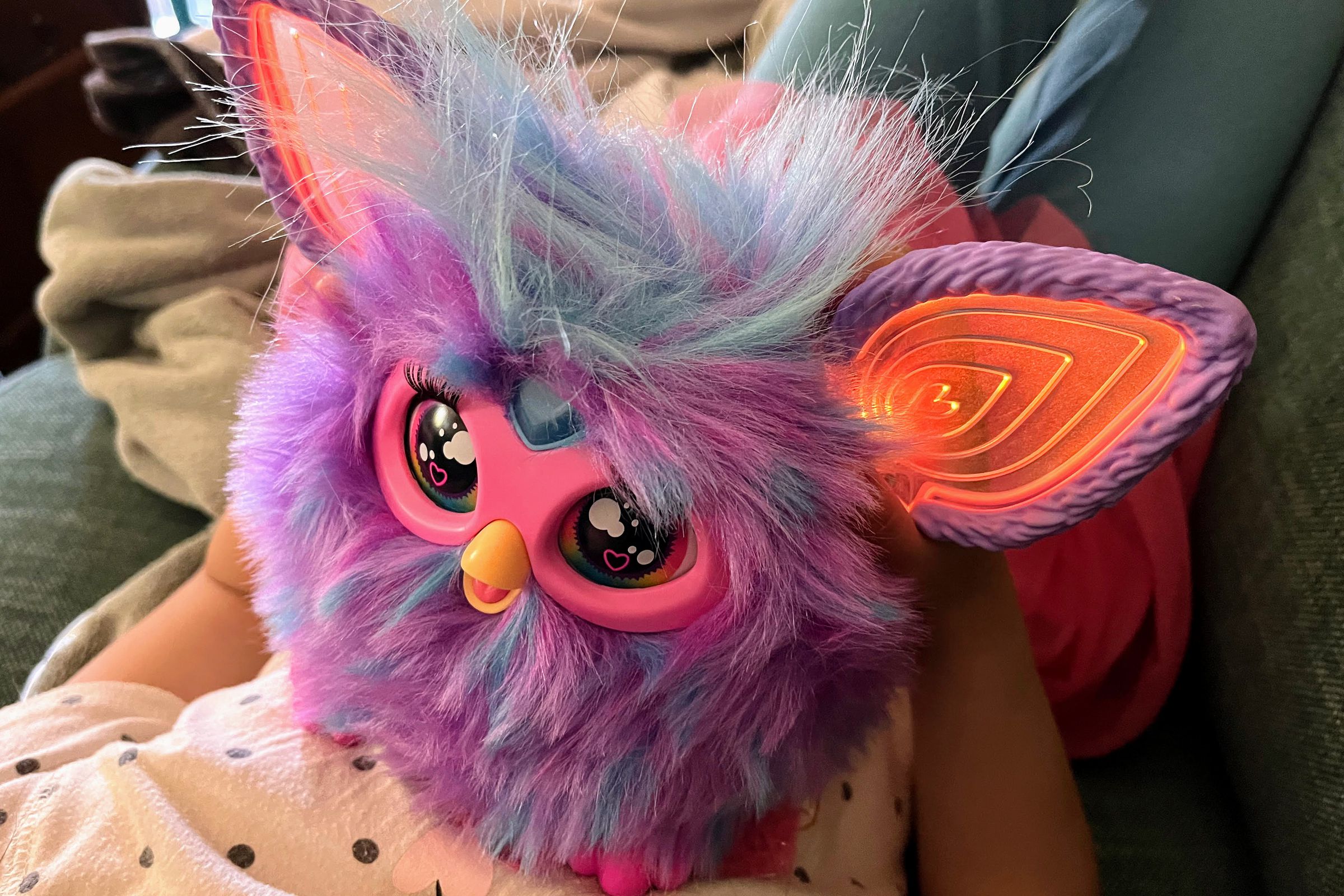 a purple fuzzball of a toy with moving eyes and ears lit by RGB LEDs and a heart button on its forehead