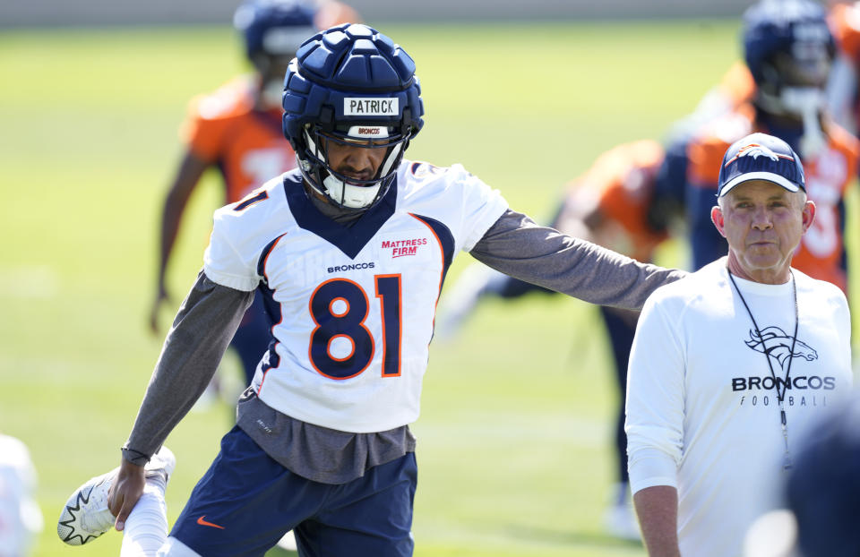 Denver Broncos wide receiver Tim Patrick, left, chats with head coach Sean Payton while warming up during NFL football training camp at the team&#39;s headquarters, Thursday, July 27, 2023, in Centennial Colo. (AP Photo/David Zalubowski)