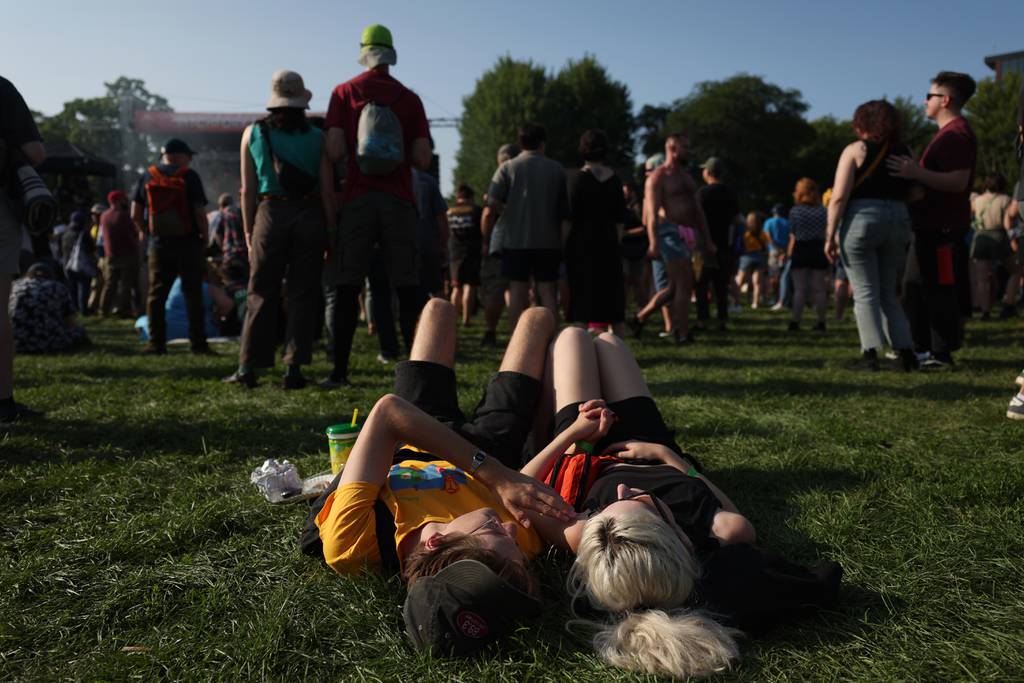 Duncan Seltzer and Petra Anderson lie in the grass as music plays at Pitchfork Music Festival on Friday, July 21, 2023, in Chicago. 