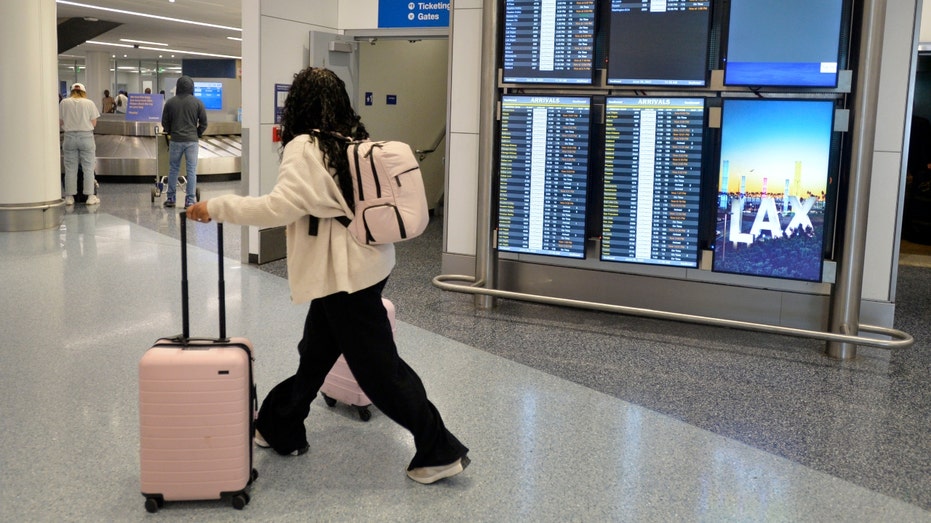 A traveler walks through LAX