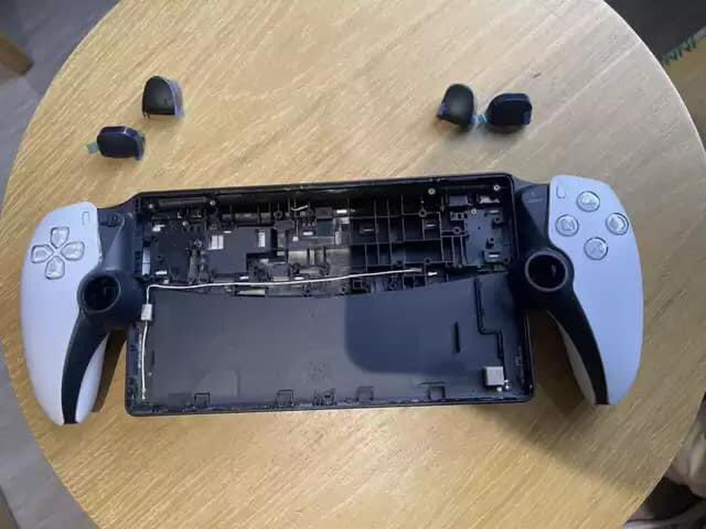 An image showing the front of the Project Q with the screen and analog sticks removed.