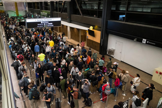 Seattle, USA - Apr 25 2023: A crowded long line at a SeaTac airport security checkpoint late in the evening.