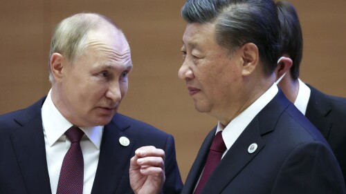 FILE- Russian President Vladimir Putin, left, gestures while speaking to Chinese President Xi Jinping during the Shanghai Cooperation Organization (SCO) summit in Samarkand, Uzbekistan, Sept. 16, 2022. Putin will this week participate in his first multilateral summit since an armed rebellion rattled Russia. Analysts say his participation at a virtual summit of the Shanghai Cooperation Organization on Tuesday is an opportunity to show he is in control after a short-lived insurrection by Wagner mercenary chief Yevgeny Prigozhin. . (Sergei Bobylev, Sputnik, Kremlin Pool Photo via AP, File)