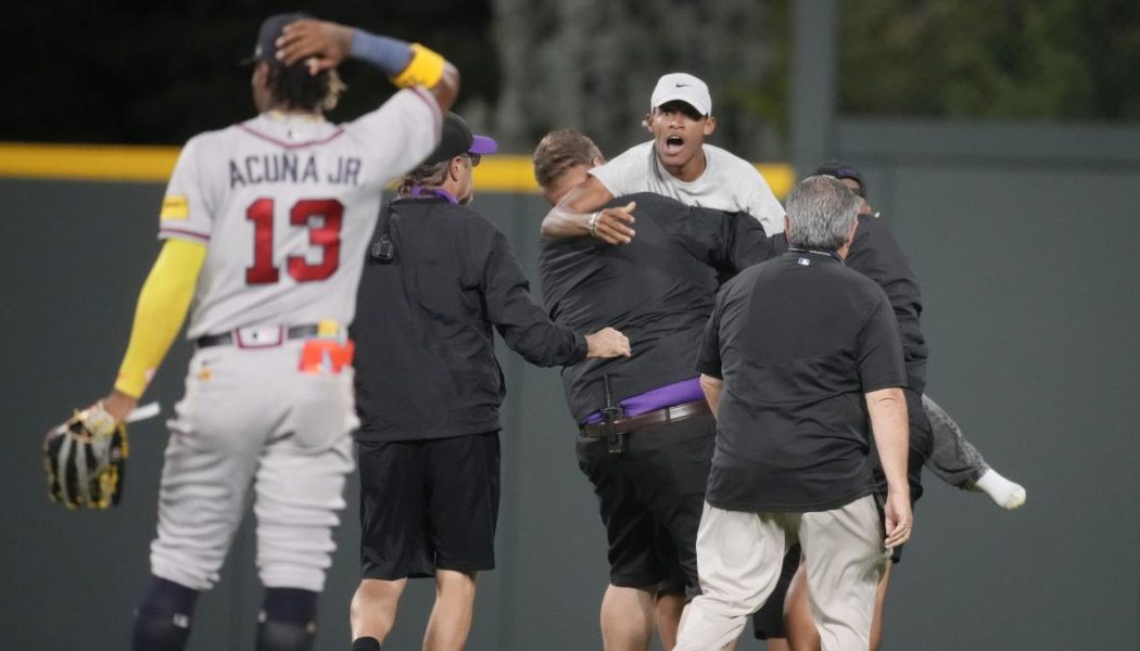 Braves star Ronald Acuna Jr. knocked over as fans run onto field in bizarre scene