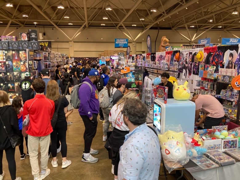 People standing admiring the different vendors featured in Fan Expo.