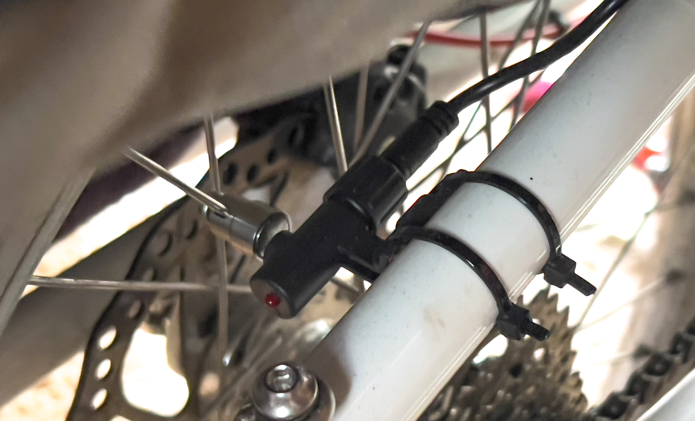 A picture of the speed sensor and magnet attached to the frame and a spoke, respectively.