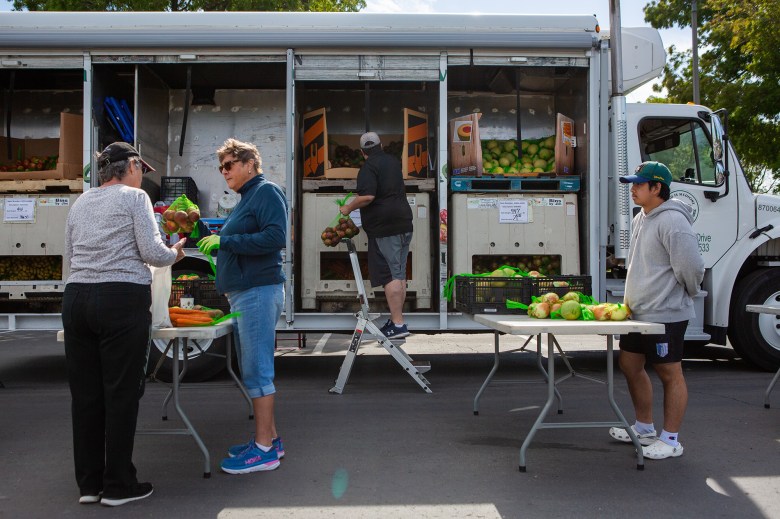 Volunteers pass out food at the Solano County Mobile Food Pharmacy in Fairfield on Aug 1, 2023. Photo by Semantha Norris, CalMatters