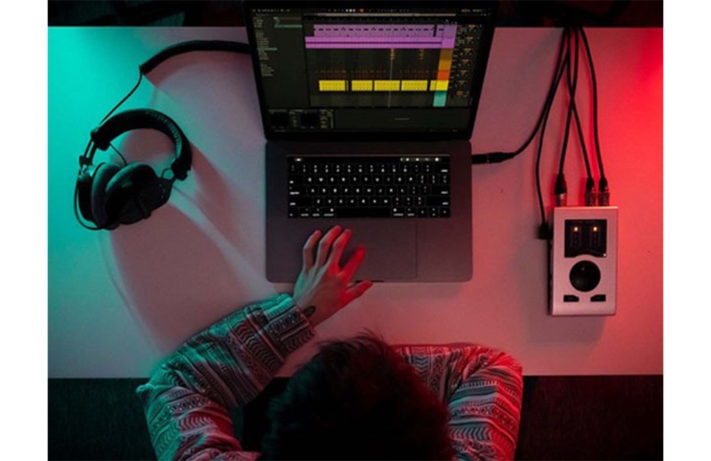 A man sits in front of a computer 