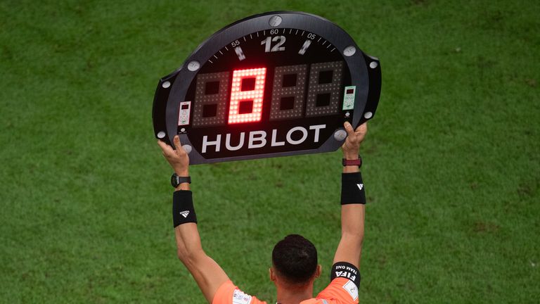 LUSAIL CITY, QATAR - DECEMBER 18: The Assistant Referee holds up the board showing eight minutes of time added on during the FIFA World Cup Qatar 2022 Final match between Argentina and France at Lusail Stadium on December 18, 2022 in Lusail City, Qatar. (Photo by Visionhaus/Getty Images)