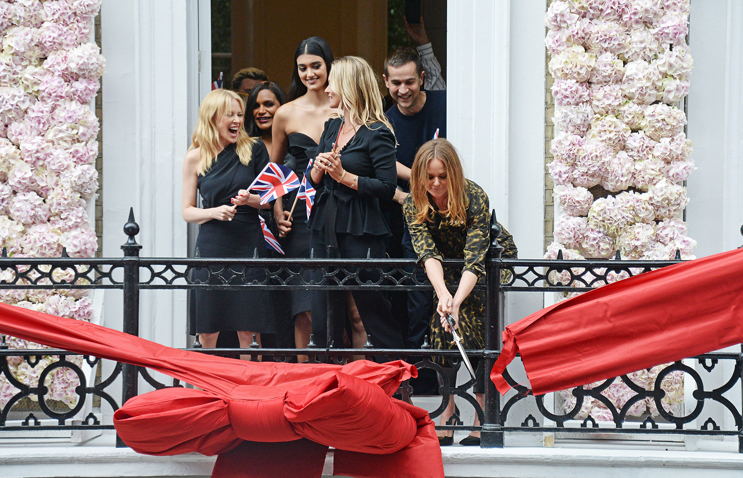 McCartney cuts the ribbon at her flagship store on Old Bond Street in London, in June 2018, with Kylie Minogue, Mindy Kaling, Neelam Gill, and Kate Moss (David M. Benett—Getty Images for Stella McCartney)