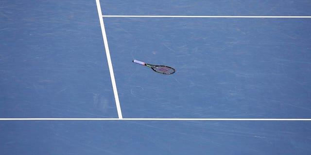 tennis racket on a hard court