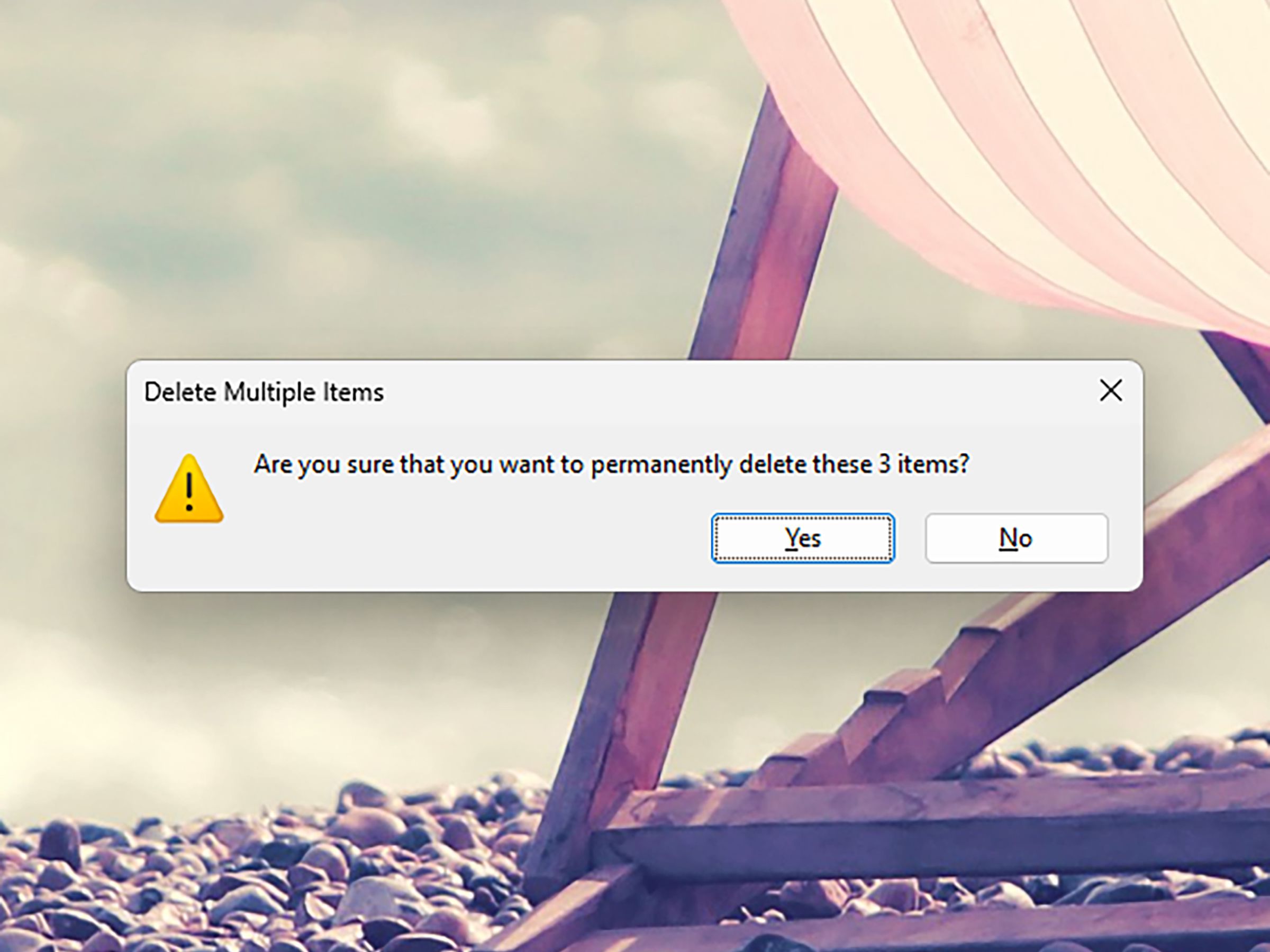 Windows background showing pebbly beach with pop-up for Delete Multiple Items.