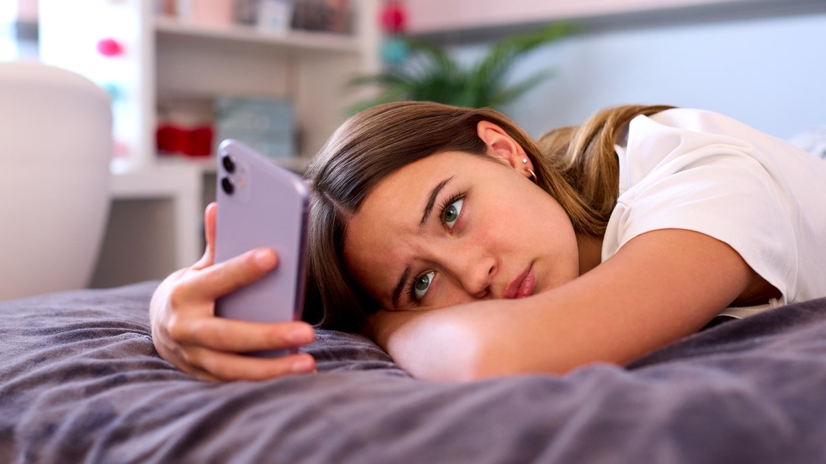 Depressed teen on phone