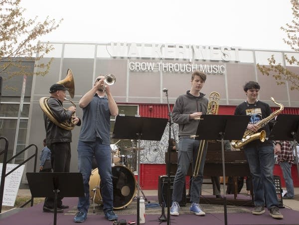 Student musicians perform on an outdoor stage